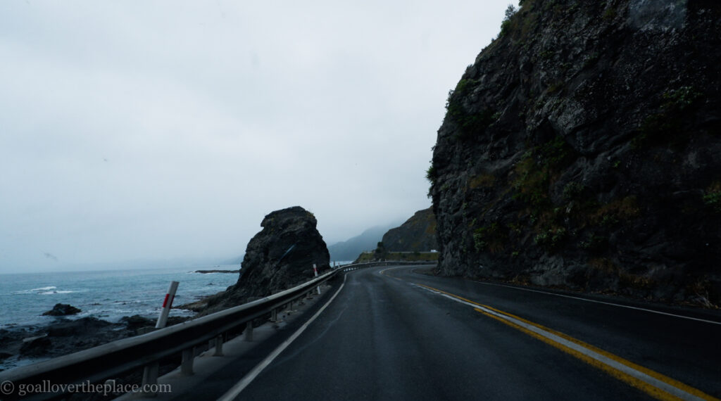 a road stretches out along the coastline of South Island, New Zealand